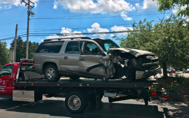 SUV clips telephone pole, sideswipes a car and crashes into brick building!