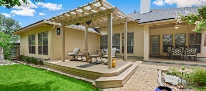 A home with a deck that matches the colors of the house and seamlessly blends in with its surroundings.